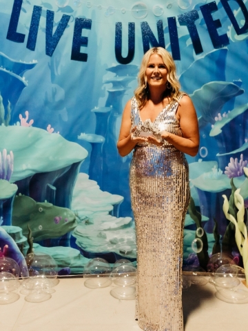 Smiling woman holding award