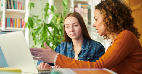 Two women sitting together at a laptop