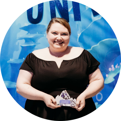 smiling woman holding award