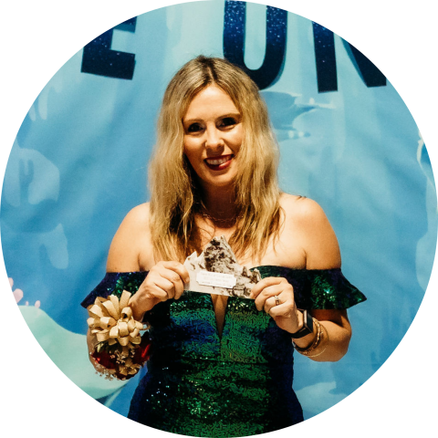 smiling woman holding award