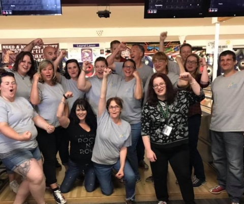Group of cheering people at a bowling alley