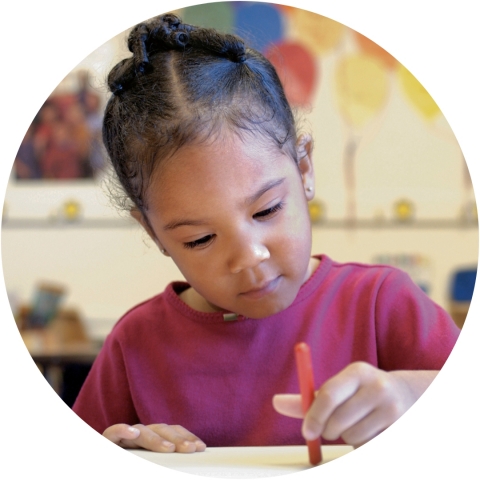 young girl using a crayon