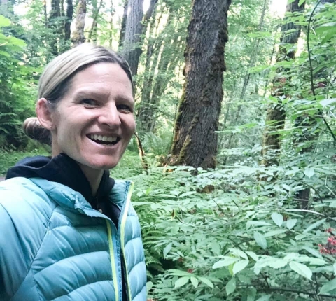 smiling woman in woods