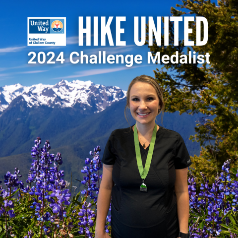 Smiling woman wearing a medal in front of mountains