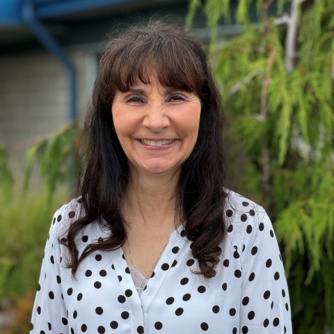 Smiling woman in polka dot top