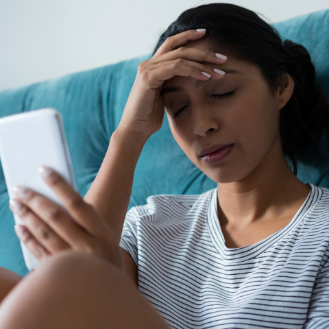 Worried looking woman with hand to her head