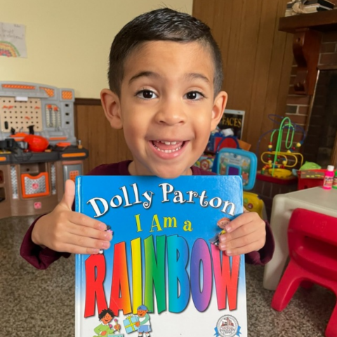 Smiling child holding a book