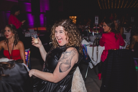 woman laughing and holding drink