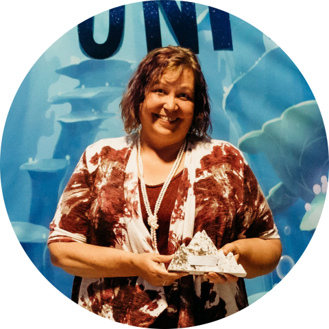 smiling woman holding award